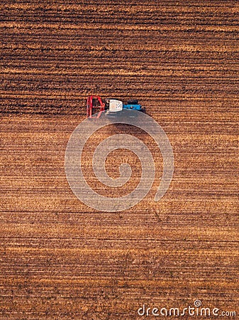 Aerial view of agricultural tractor doing stubble tillage Stock Photo