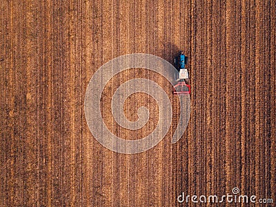 Aerial view of agricultural tractor doing stubble tillage Stock Photo