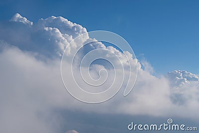 Aerial view from airplane of rain clouds and blue sky Stock Photo