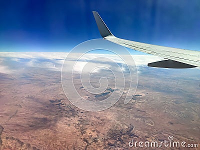 Aerial view from the airplane window with blue horizon. Editorial Stock Photo