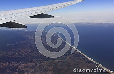 Aerial view of an airplane wing over California coast Stock Photo