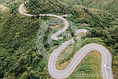 Aerial view of amazing road with green forest and mountain,Bird's eye view from drone Stock Photo