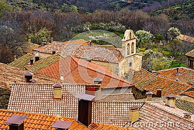 Aerial view of ancient stone town with its red roofs of old tiles and its church tower. La Hiruela Madrid Stock Photo