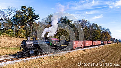 Aerial View of an Antique Steam Freight Passenger Train Blowing Smoke as it Slowly Travels Editorial Stock Photo