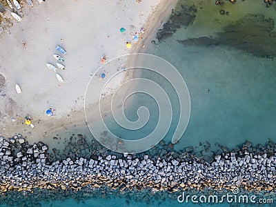 Aerial view of a beach with canoes, boats and umbrellas. Pier of Pizzo Calabro, Calabria, Italy Stock Photo
