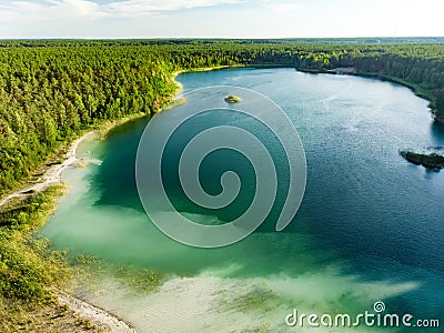 Aerial view of beautiful green waters of lake Gela. Birds eye view of scenic emerald lake surrounded by pine forests Stock Photo