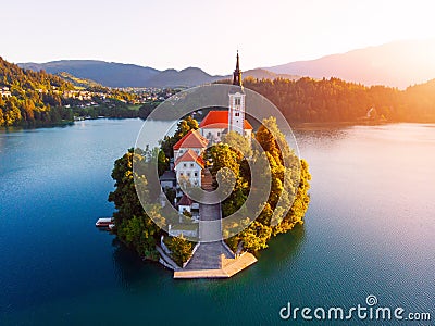 Aerial view of beautiful Lake Bled in the middle of the charming little island and the wonderful church at autumn sunrise Stock Photo