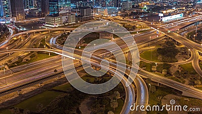 Aerial view on Dubai Marina with big highway intersection night timelapse and skyscrapers around, UAE Stock Photo