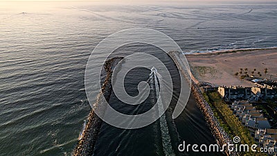 Aerial view of a boat on the Manasquan Inlet heading for the Atlantic Ocean in Manasquan Editorial Stock Photo