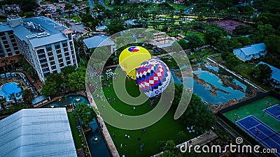 Aerial view of brightly-colored hot air balloons in a park preparing to take off Editorial Stock Photo