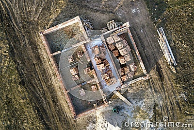 Aerial view of building site. Trenches dug in ground and filled with cement as foundation for future house, brick basement floor Stock Photo