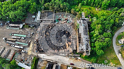 Aerial view of a burning building situated near a wooded area Editorial Stock Photo