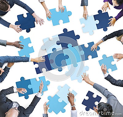 Aerial View of Business People Piecing Puzzle Pieces Stock Photo