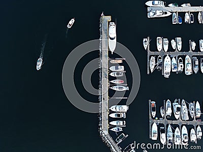 Aerial view of a bustling marina with a variety of different-sized boats docked in the water. Stock Photo