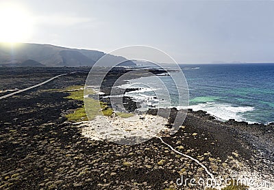 Aerial view of the Caleta del MojÃ³n Blanco, sandy desert beach and rugged coastline. Lanzarote, Spain. Africa Stock Photo