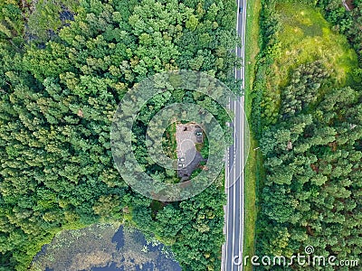 Aerial view on car parking in forest with round lake Stock Photo