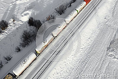 Aerial view of cargo train tank wagons, a double-track railway. Winter rail road with white snow, top view Stock Photo