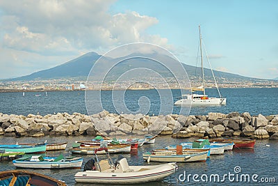 Crater Vesuvius, catamaran and dinghies in small port in Naples. Stock Photo