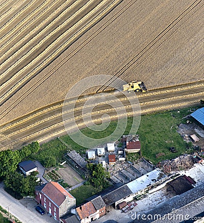 Aerial View : Cereal harvest close by a farm Stock Photo