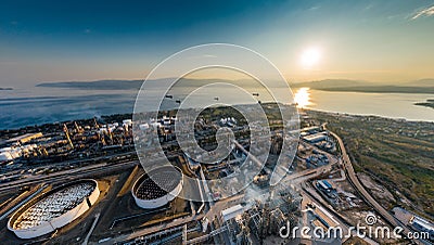 Aerial view of Chemical plant at sunset, oil refining, smoke, pipes, ecology pollution, air infection, coast of sea in Stock Photo