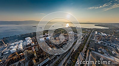 Aerial view of Chemical plant at sunset, oil refining, smoke, pipes, ecology pollution, air infection, coast of sea in Stock Photo