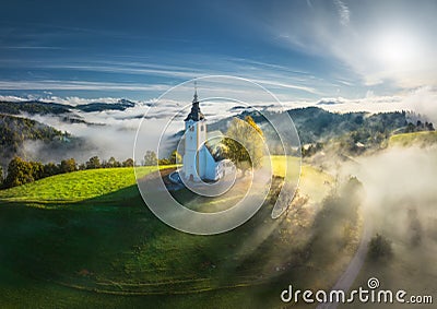 Aerial view of church on the hill in low clouds at sunrise Stock Photo