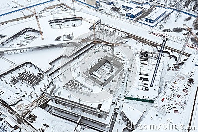 Aerial view of city construction site with working cranes in winter Stock Photo