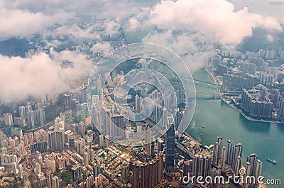 Aerial view through the clouds to a large metropolis city of Hong Kong. Stock Photo