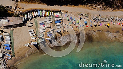 Aerial view of colorful kayaks and tourists on a sandy beach Editorial Stock Photo