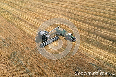 Aerial view of combine harvester. Harvest of rapeseed field. Industrial background on agricultural theme. Biofuel Editorial Stock Photo