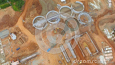 Aerial view of a construction site with trailers unloading raw m Stock Photo