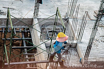 Authentic construction worker busy on the positioning of formwork frames in construction site Editorial Stock Photo