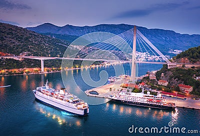 Aerial view of cruise ship at harbor and bridge at night Stock Photo