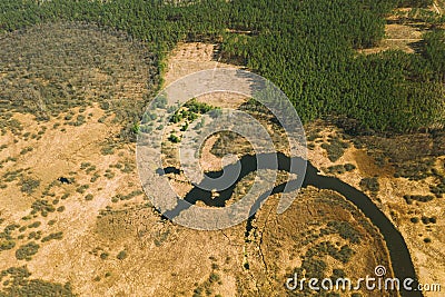 Aerial View Curved River In Early Spring Landscape. River bends Curves and dry grass landscape. Top View Of Beautiful Stock Photo