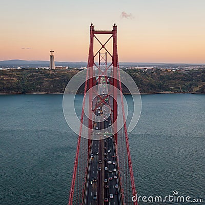 Aerial View of 25 de Abril Bridge Over the Tagus River at Sunset in Lisbon, Portugal Stock Photo