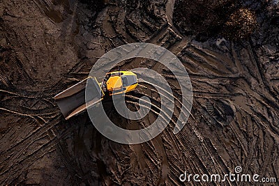 Aerial view above an earth mover truck on a muddy construction site Stock Photo