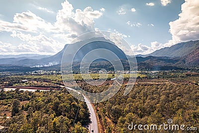 Aerial view of Doi Luang Chiang Dao mountain with the road among the autumn forest on bright day at Chiang Dao Stock Photo