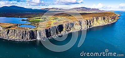 Aerial view of the dramatic coastline at the cliffs by Staffin with the famous Kilt Rock waterfall - Isle of Skye - Stock Photo