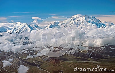 Aerial View of Dramatic Peaks Looming Out of the Clouds Stock Photo