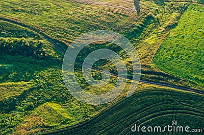 Aerial view from drone or aerostat in countryside rural farmland with green field hills and meadows, top view landscape Stock Photo