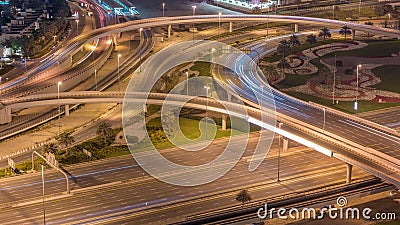 Aerial view on Dubai Marina with big highway intersection night timelapse and skyscrapers around, UAE Stock Photo