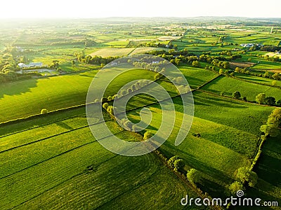 Aerial view of endless lush pastures and farmlands of Ireland. Beautiful Irish countryside with emerald green fields and meadows. Stock Photo