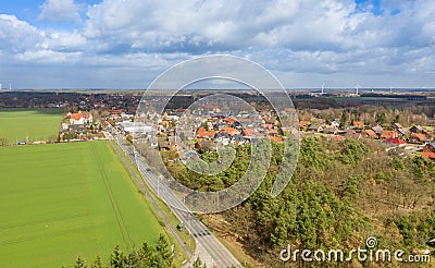 Aerial view of the entrance of a German small town with a country road between fields and woods for the development of the village Stock Photo