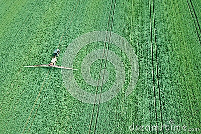 Aerial view Farm machinery spraying chemicals on the large green Editorial Stock Photo