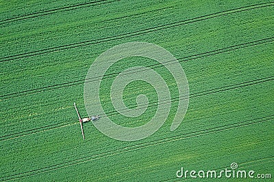 Aerial view Farm machinery spraying chemicals on the large green Stock Photo