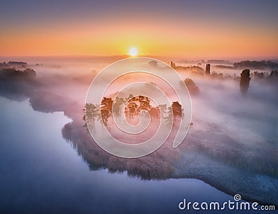 Aerial view of foggy forest at colorful sunrise in autumn Stock Photo