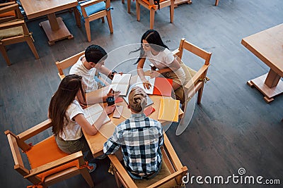 Aerial view. Four young students in casual clothes have meeting at rainy day Stock Photo