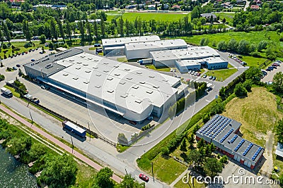 Aerial view of goods warehouse. Logistics center in industrial city zone from above. Aerial view of trucks loading at logistic Stock Photo