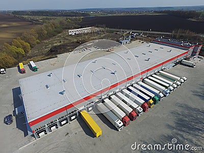 Aerial view of goods warehouse. Logistics center in industrial city zone from above. Stock Photo