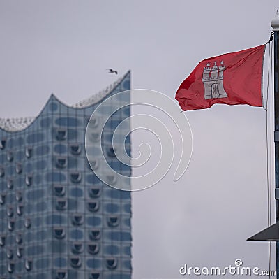 Aerial view of Hamburg flag waving in background of Elbe Philharmonic Hall building Editorial Stock Photo